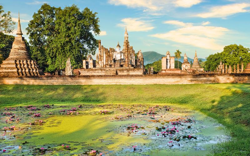 Ayutthaya Historical Park, a listed UNESCO Heritage Site, with historical ruins glow under the golden sunshine