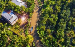 Aerial view of lush coconut forests and winding canals in Ben Tre, a peaceful destination in Vietnam’s Mekong Delta