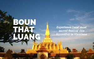 Pha That Luang golden Buddhist stupa in Vientiane, Laos, under a clear blue sky, featuring text for the Boun That Luang festival in November.