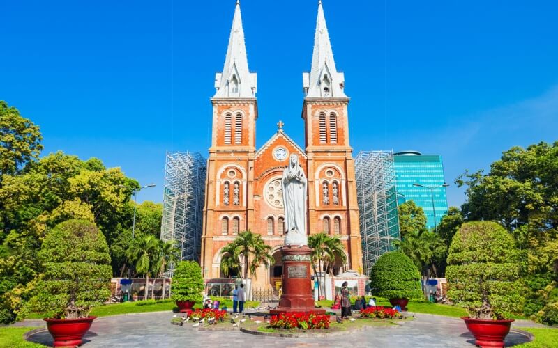 Notre-Dame Cathedral Basilica of Saigon in Ho Chi Minh City, Vietnam, with its iconic twin bell towers and red brick facade